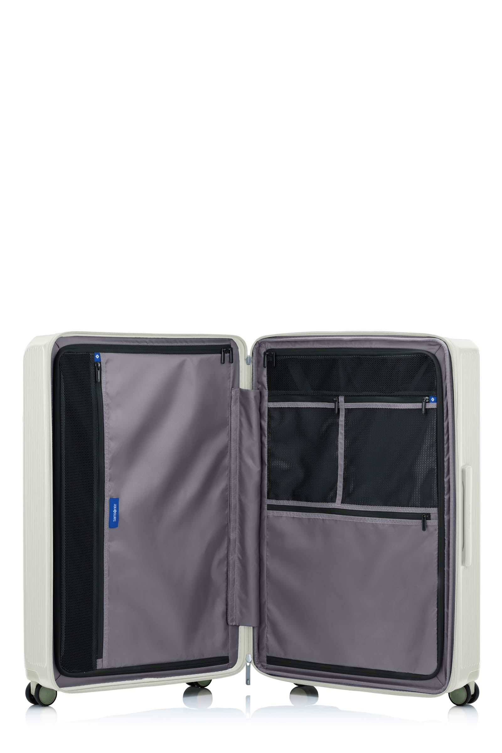 Open main compartment of the Samsonite Voypod Spinner large in Ivory, showing the grey Recyclex™ lining, compression straps, and zippered organization pockets. Shop Now Online