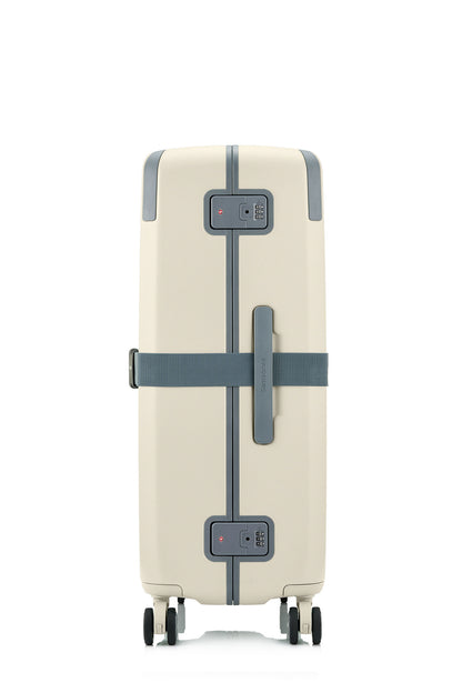 Side view of the Evox Spinner Large luggage in Beige strapped. Shop the Collection Online.