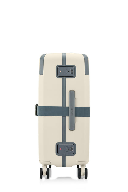 Side view of the Evox Spinner Medium luggage in Beige strapped. Shop the Collection Online.